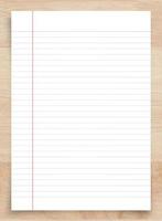 White paper sheet on wood with clipping path. White notebook paper for background. photo