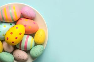 Happy Easter. Colored easter painted eggs in a bowl with copy space