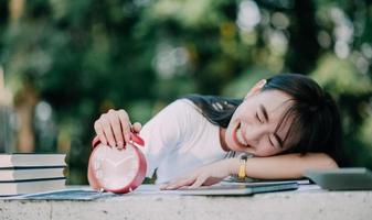 success at work Asian girl lying on the table with a successful gesture with a smile of joy in his work photo