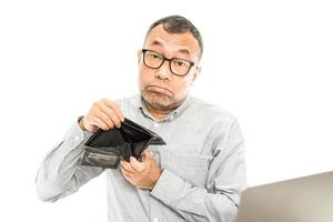 Asian men show no money in their wallets. the concept for recession, bankrupt, bankruptcy, sad, crisis, stress, unhappy. Copy space on left and right for design or text, closeup, white blur background photo