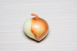 The ripe onion on a tiled floor photo