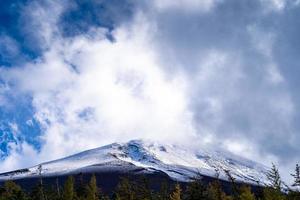 Close up top of Fuji mountain with snow cover and wind on the top with could in Japan. photo