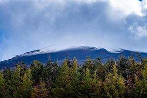 Close up top of Fuji mountain with snow cover and wind on the top with could in Japan. photo