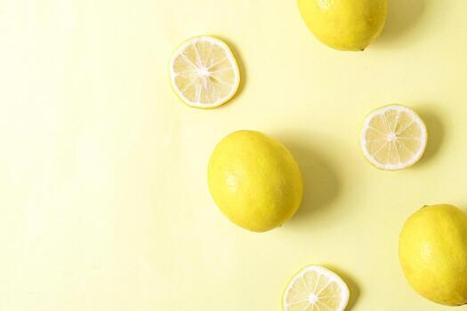 Row of lemon slices texture on yellow background in creative flat lay composition with copy space photo