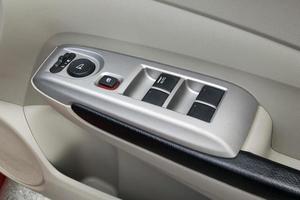 car interior details of door handle with windows controls and adjustments photo