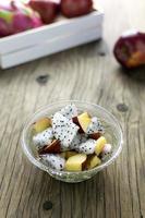 fruit salad in a bowl on the wooden table. Selective focus. photo