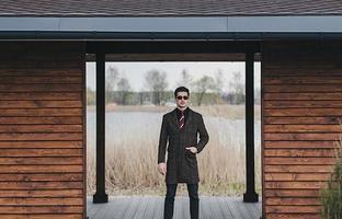 man in coat and sunglasses photo