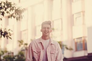 Handsome fashion man in stylish in a white jacket photo