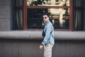 man with a bag of denim clothes photo