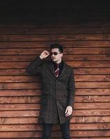 elegant man in trendy coat and glasses photo