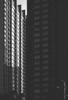 Sunlight and shadow on surface of high residential condominiums in the city, black and white style and vertical frame photo