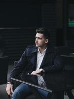 handsome successful man is sitting at a table photo