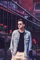 Portrait of a handsome young man in denim jacket photo