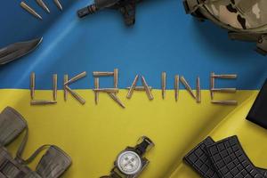 Ammunition on the Ukrainian flag concept. Russian-Ukrainian conflict. Desk with Ukrainian military equipment. Top view, flat lay photo