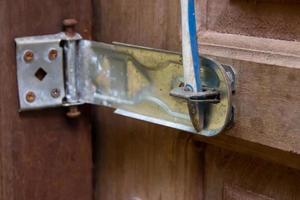 wooden house door lock jammed with objects photo