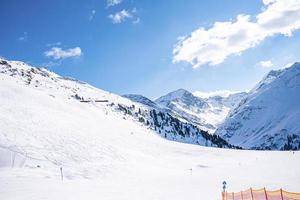 Beautiful snow covered mountain range against sky in alps photo