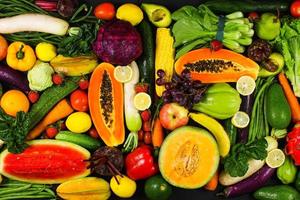 Healthy food background of assorted fresh fruits and vegetables in creative flat lay composition