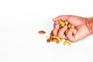 Concept, trail mix day. handful men trail mix on white background. closeup. copy space on left for design or text.