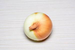 The ripe onion on a tiled floor photo