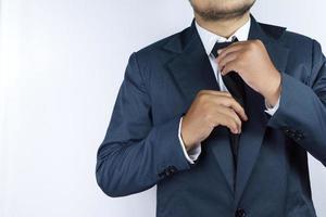 businessman is fixing tie photo