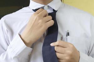 Businessman is fixing a blue tie photo