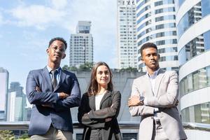 Group of business people.Business people meeting talking and sharing their ideas in city. Business team and teamwork concept. Business people standing outside in the city discussing about new project. photo