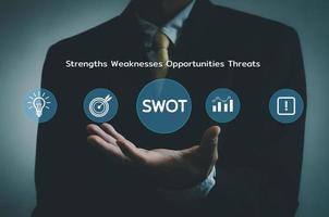 Hand businessman icon SWOT strengths weaknesses opportunities threats  virtual screen.Business marketing Concept. photo