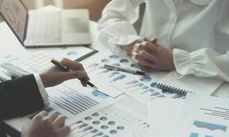 Business team analyzing income charts and graphs with modern laptop computer. Close up.Business analysis and strategy concept. photo