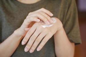 Woman applying moisturizing hand cream, Concept of health care of the hand. photo