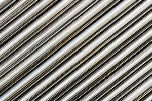 Texture of chrome steel pipe sort in diagonal, abstract background photo