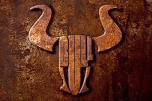 Bull sign concept on metal rust background photo