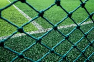Net in front of artificial turf of Soccer football field.