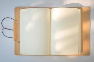 Blank Notebook on a White Paper Background photo