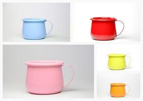A colorful set of colored zinc mugs or cups. photo