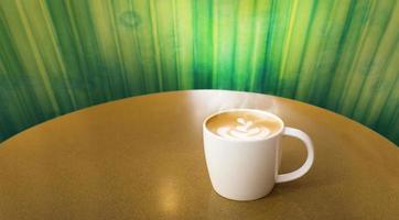 late art coffee in ceramic cup on table photo