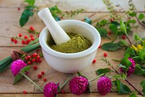 Fresh herbs powder in the mortar, alternative medicine photo