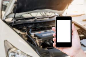 woman using mobile phone with broken down car photo