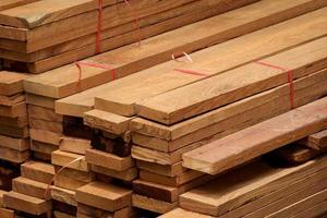 Stack of many wooden planks in construction site, construction material background photo