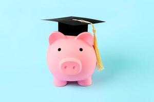 Pink piggy money bank with graduation cap photo