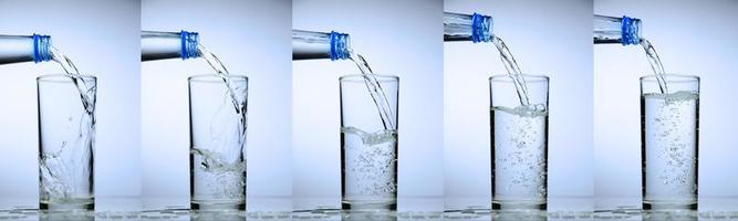 glass is filling up with water. water splash collection on white background. photo