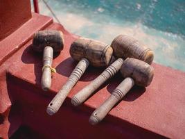 Wooden hammer on cement ground photo