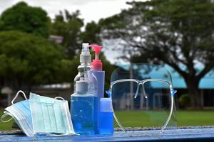 Hand sanitizer gel and facemasks to clean hands and wear before getting inside to protect and prevent Covid-19 virus or Coronavirus and germs. photo