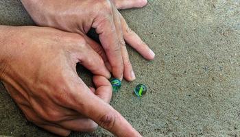 Cianjur Regency, West Java Indonesia, on April 05, 2022 - How to play marbles the Indonesian people. photo