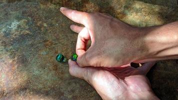 Cianjur Regency, West Java Indonesia, on April 05, 2022 - How to play marbles the Indonesian people. photo