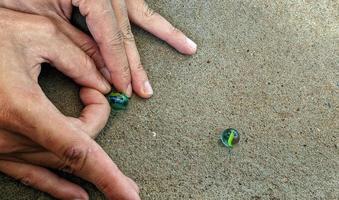 Cianjur Regency, West Java Indonesia, on April 05, 2022 - How to play marbles the Indonesian people. photo