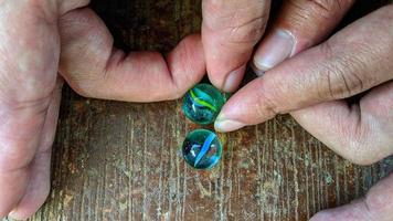 Cianjur Regency, West Java Indonesia, on April 05, 2022 - How to play marbles the Indonesian people. photo