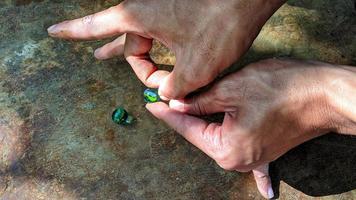 Cianjur Regency, West Java Indonesia, on April 05, 2022 - How to play marbles the Indonesian people. photo