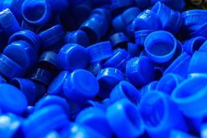 Blue plastic caps used to seal beverage bottles. photo