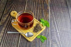 tea in glass cup on wooden background photo