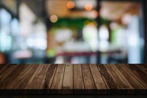 Wood table with blur cafe or coffee shop background. photo